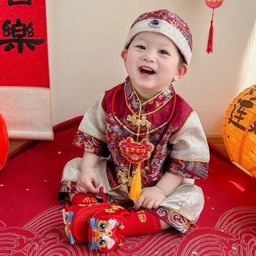 Child in Traditional Chinese Red Short Sleeves Baby Tang Jacket Set with festive decorations in the background