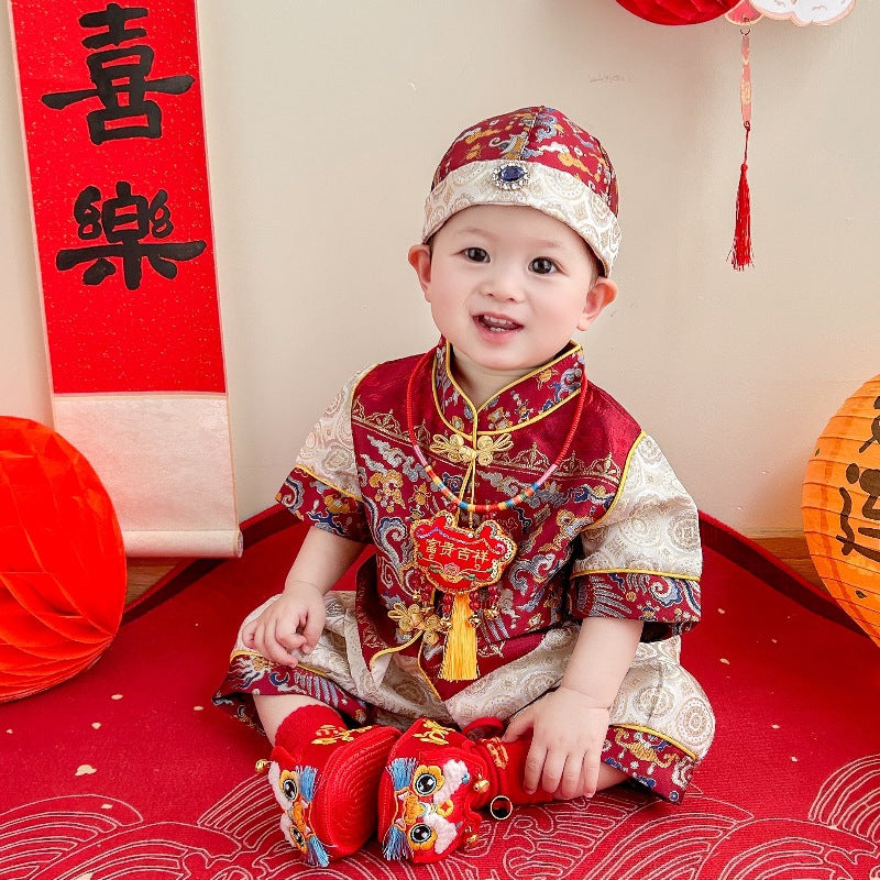 A chinese baby in Red Short Sleeves Baby Tang Jacket and pants sitting on the floor