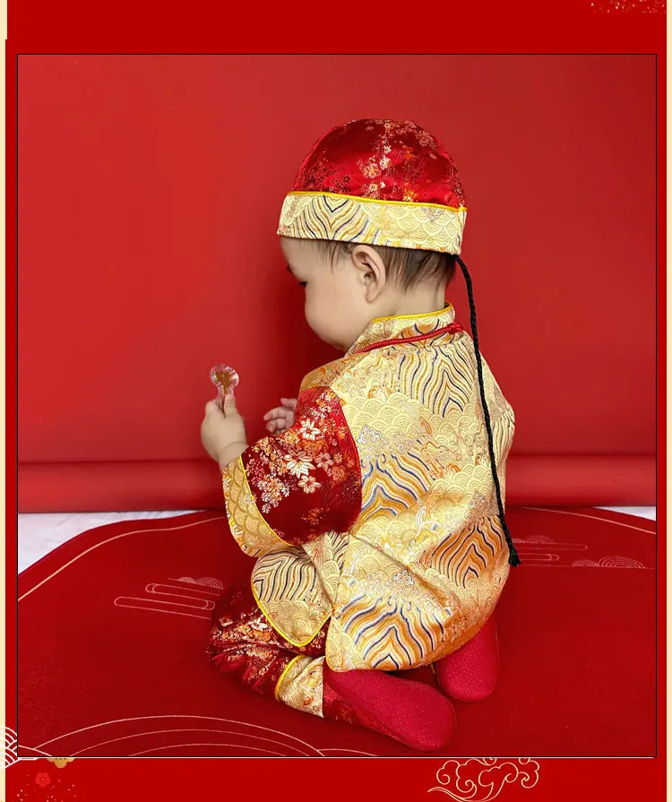 Child in traditional chinese tang outfit with red hat on a red background