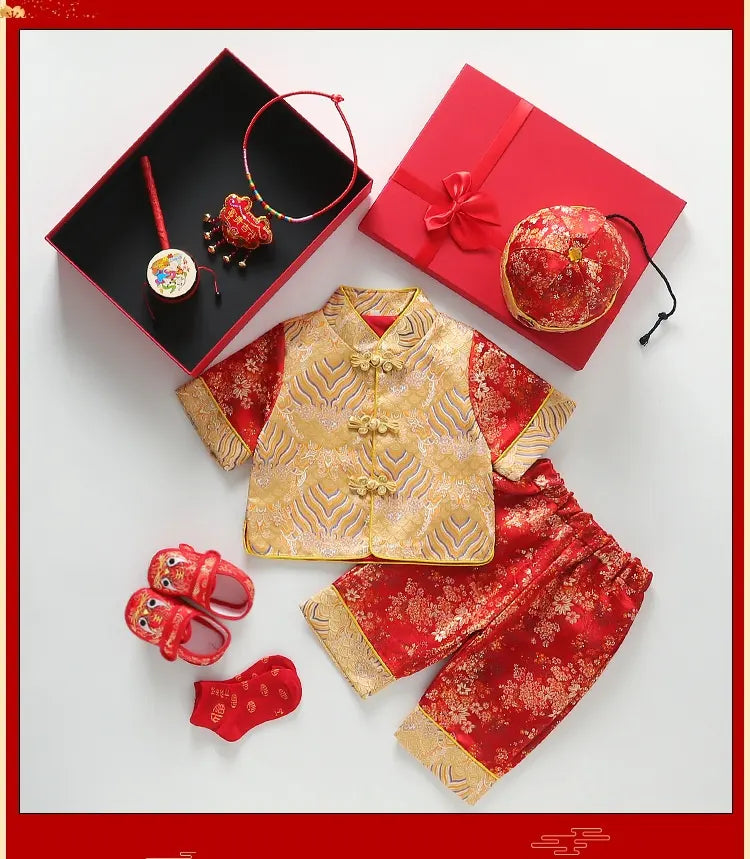 Traditional Chinese children's outfit with gold and red elements on a white background