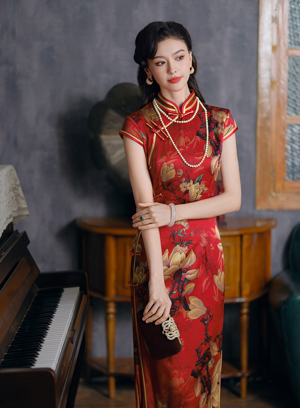 a chinese girl in red long floral silk qipao