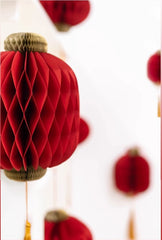  red honeycomb paper lantern with gold tassel, perfect for festive occasions like Chinese New Year or weddings