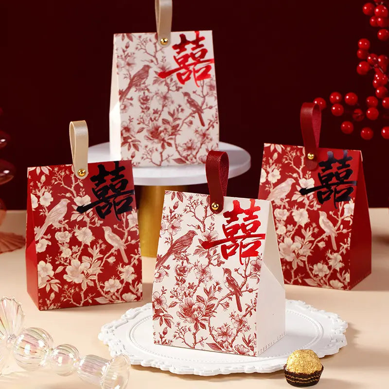 Retro Chinoiserie Bird & Floral Wedding Candy Gift Boxes bags with red and white patterns on a table with a red background.