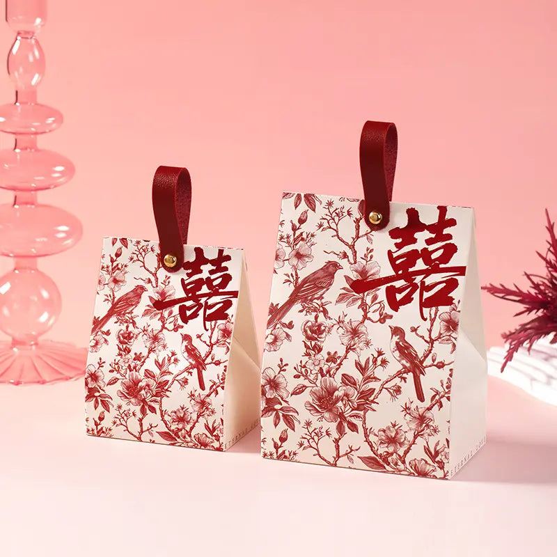 Two Retro Chinoiserie Bird & Floral Wedding Candy Gift Boxes on a pink background