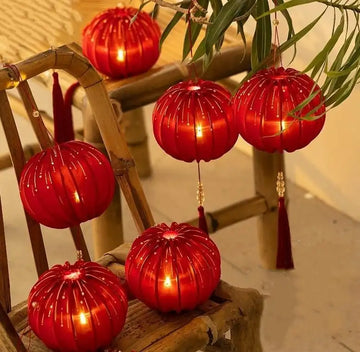 Round Red Fabric Lantern with Light and Tassels for Lunar New Year, Mid-Autumn Festival, weddings, and other celebrations.
