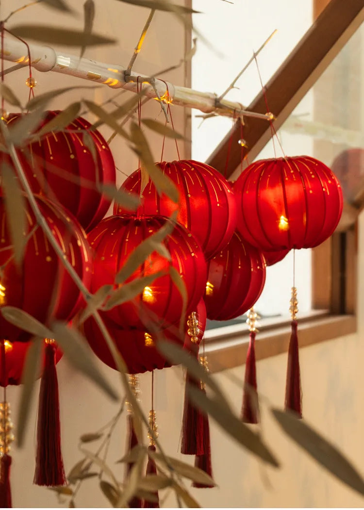 Round Red Fabric Lantern with Light and Tassels for Lunar New Year, Mid-Autumn Festival, weddings, and other celebrations.