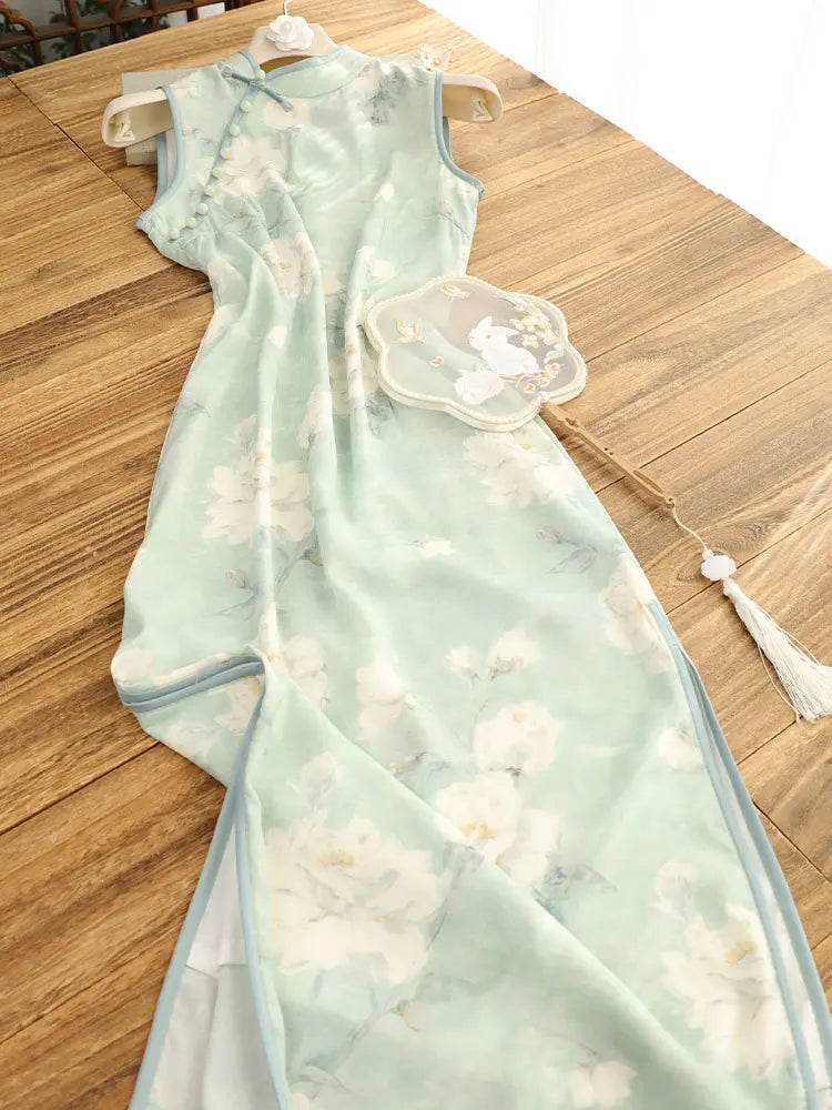 Sage Green Floral Neo-Chinese Sleeveless Qipao Dress  with floral patterns on a wooden surface