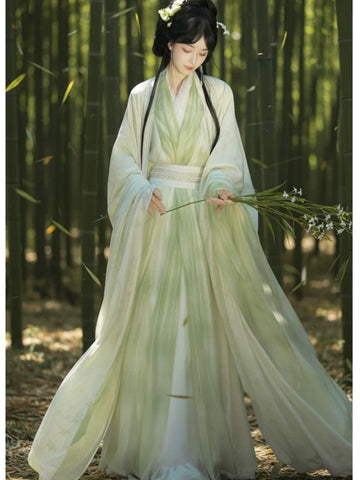 Woman in traditional chinese Sage Green Traditional Wei-Jin Style Double-Layer Hanfu Dress Set  dress holding flowers in a bamboo forest