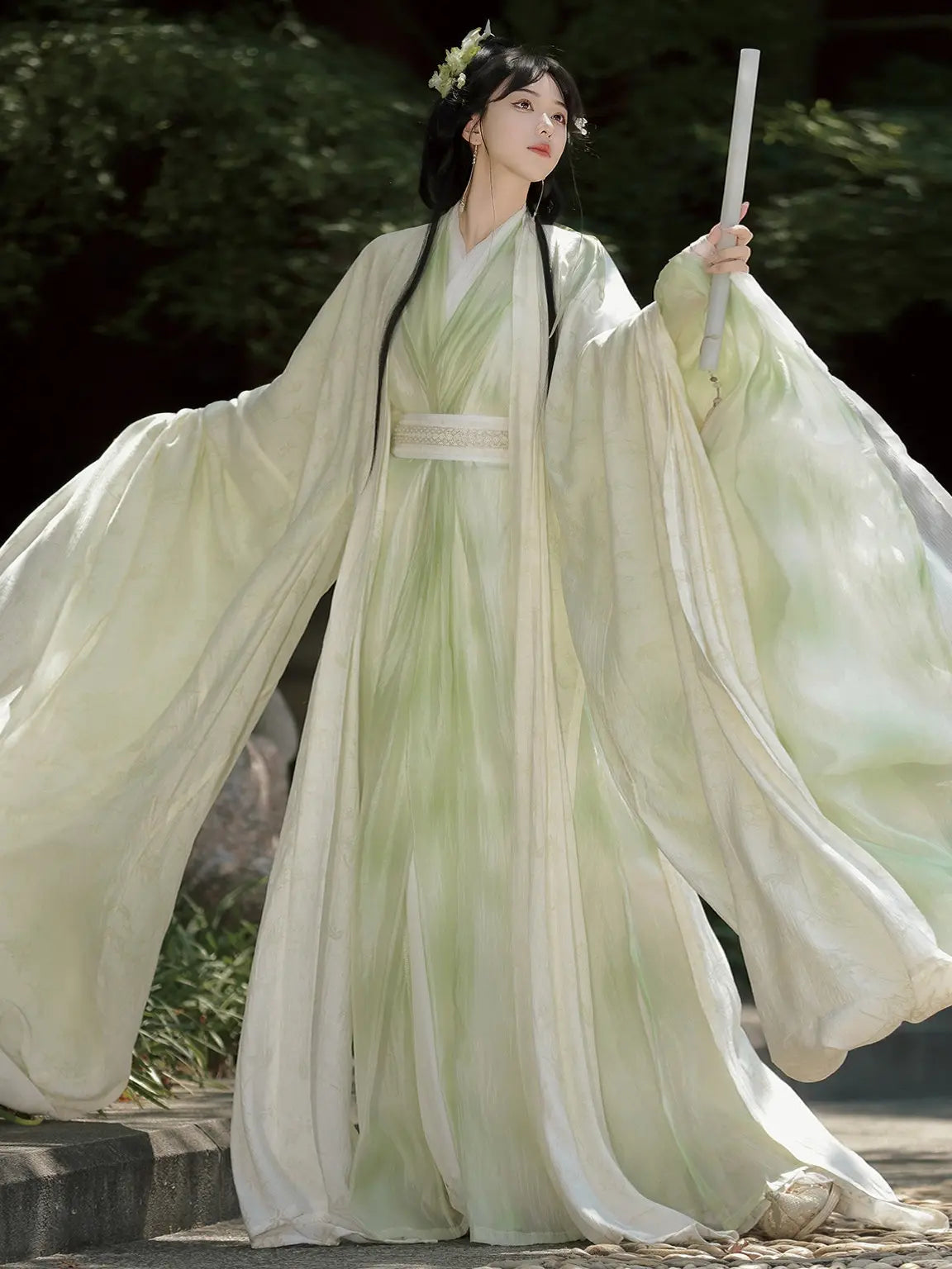 Woman inSage Green Traditional Wei-Jin Style Double-Layer Hanfu Dress Set dress with flowing sleeves outdoors