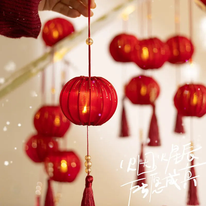 Red lanterns with tassels hanging against a blurred background