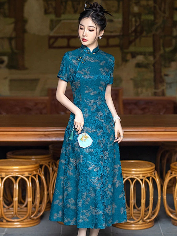 A woman wearing a Teal Blue 3D Textured Floral Jacquard A-Line Qipaocheongsam dress with floral patterns, standing in a traditional Chinese-style interior with wooden stools and a table.