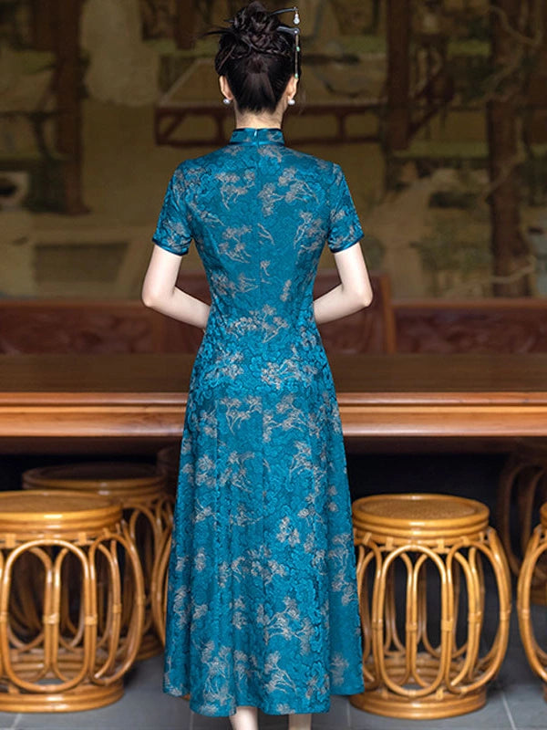 A woman viewed from behind wearing a  Teal Blue 3D Textured Floral Jacquard A-Line Qipao cheongsam dress, standing in front of a wooden table and rattan stools. 