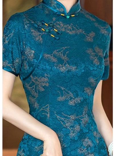 A close-up of a woman wearing a Teal Blue 3D Textured Floral Jacquard A-Line Qipao  cheongsam dress with floral embroidery and traditional frog closures at the collar.