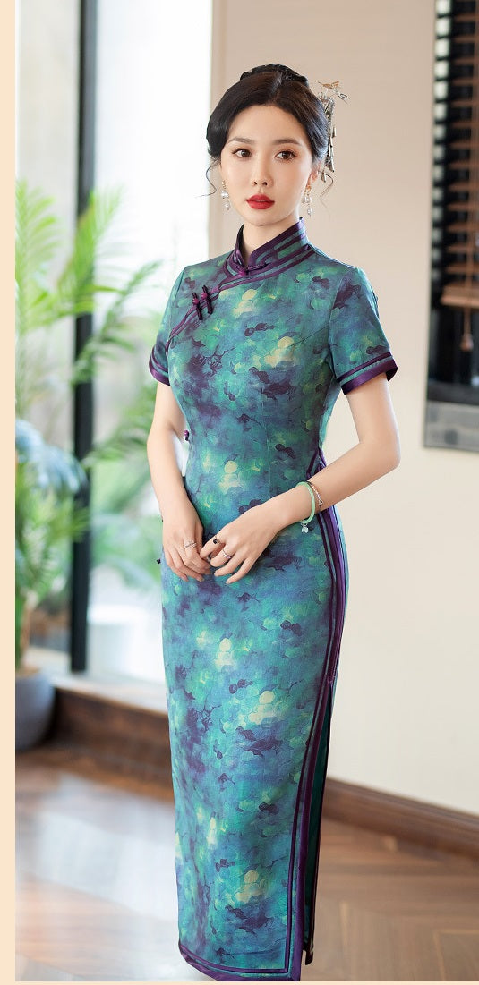 A chinese girl in  teal, blue, and purple foral cheongsam dress standing