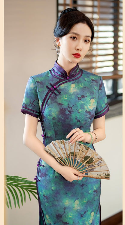 A chinese girl in  teal, blue, and purple foral qipao dress standing with hand fan on hand