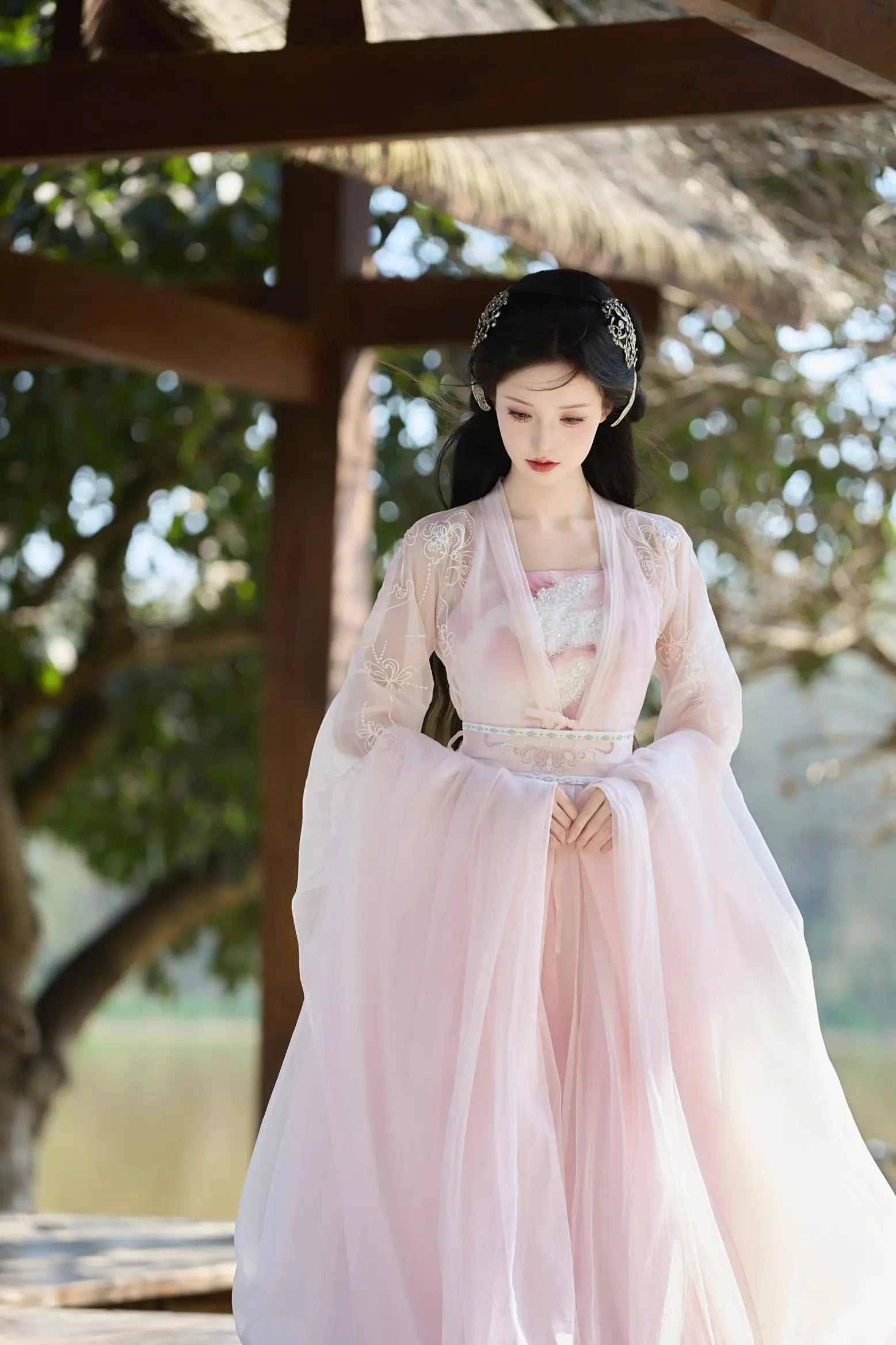 Woman in a Traditional Chinese Clothing - Pink Tang Dynasty Hezi Qun Hanfu Dress standing outdoors with trees in the background
