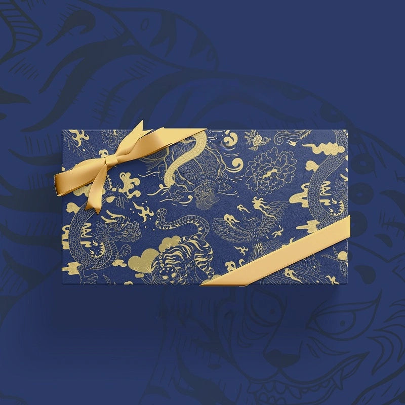 A rectangular gift box wrapped in dark blue paper with a gold dragon pheonix pattern, tied with a matching gold ribbon and bow, set against a dark blue background with subtle dragon motifs.
