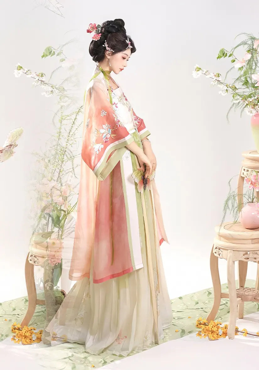 Woman in pink Traditional Chinese Dress – Elegant Song Dynasty Hanfu Set with floral decorations in a decorated room.