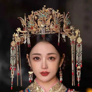 Woman wearing an elaborate traditional Traditional Chinese Ming Dynasty Golden Bridal Phoenix Crown headpiece Set  with intricate designs and decorations.