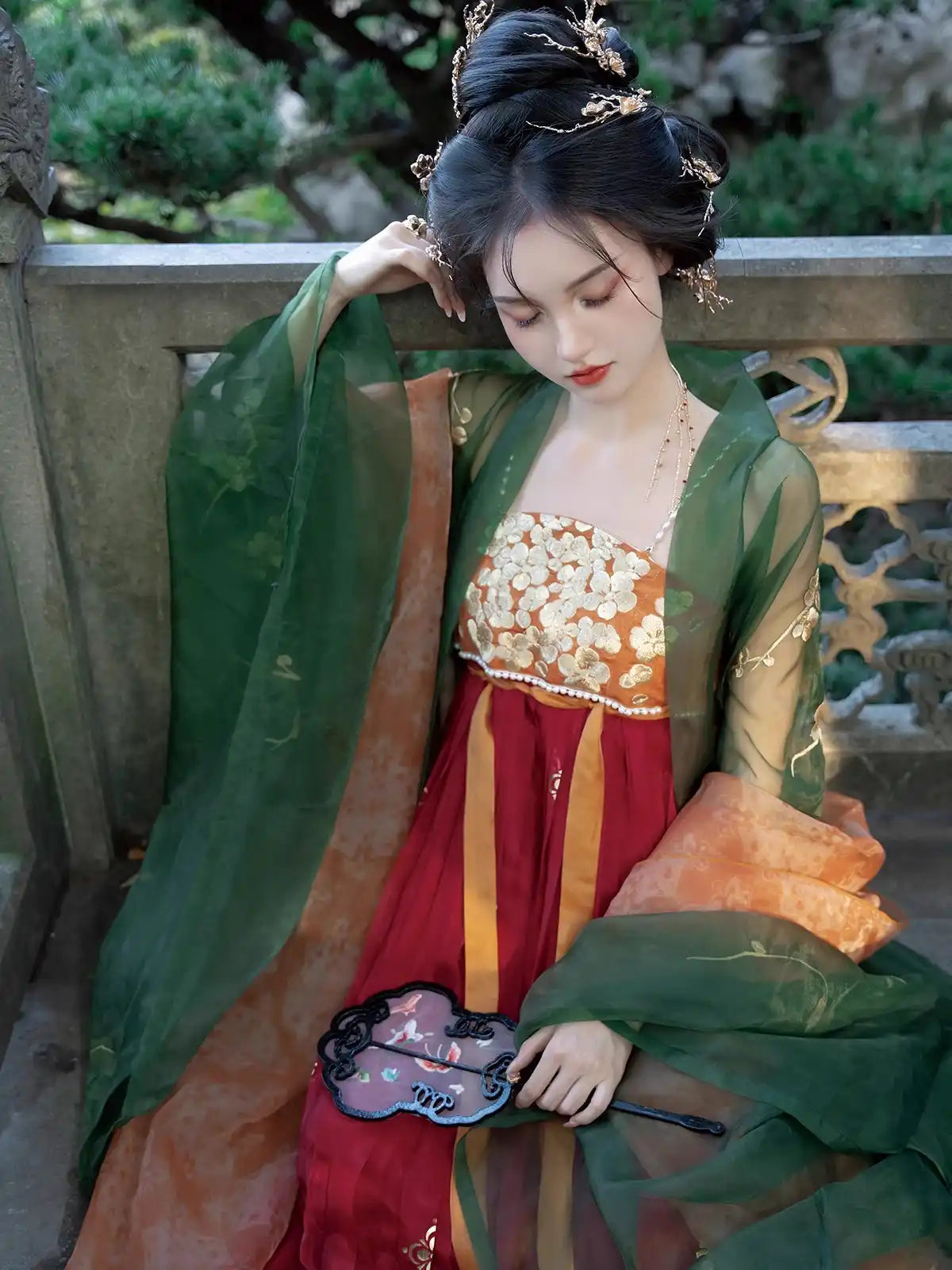 Woman in Traditional Chinese Tang Dynasty Green Hanfu Dress  attire with a green and red dress, standing outdoors.