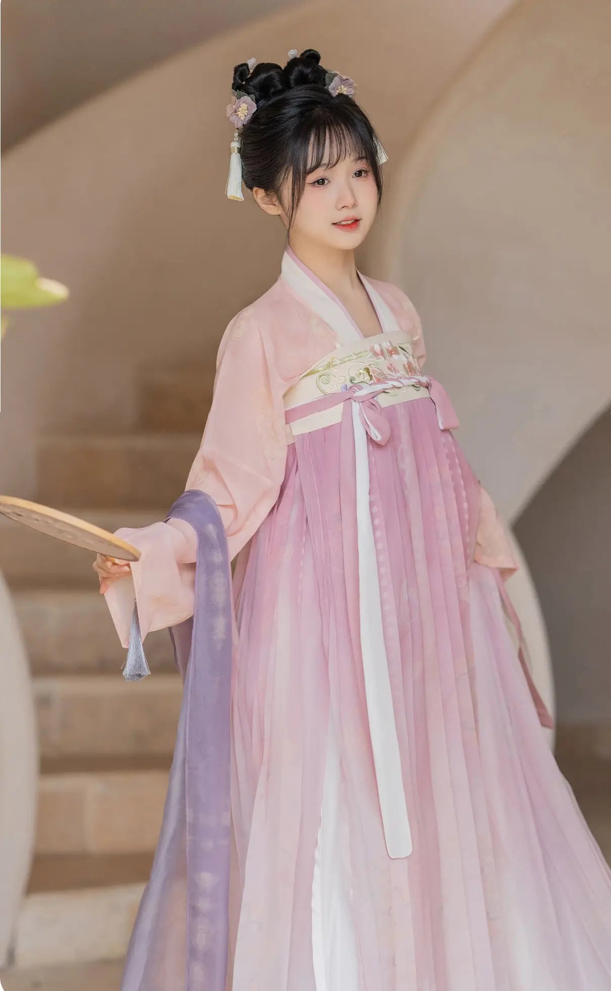 Woman in a Traditional Chinese Tang Dynasty Pink Hanfu Dress Clothing   with floral patterns, holding a fan.