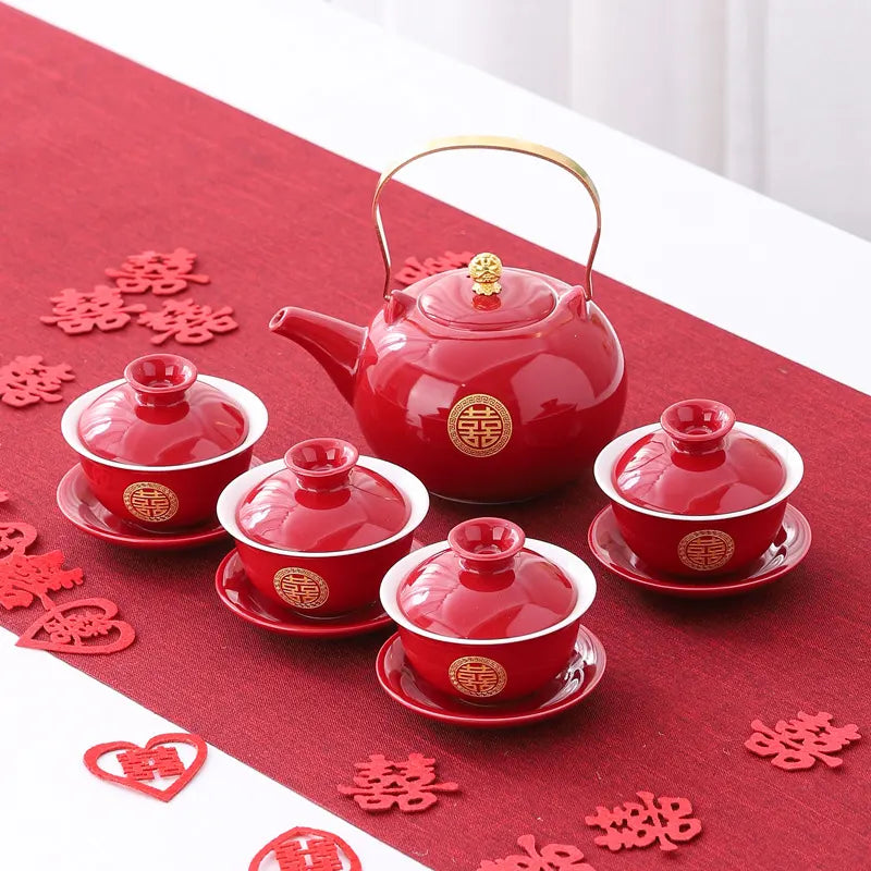 Traditional Chinese Wedding Double Happiness Teapot Set with matching cups on a red tablecloth with decorative characters.