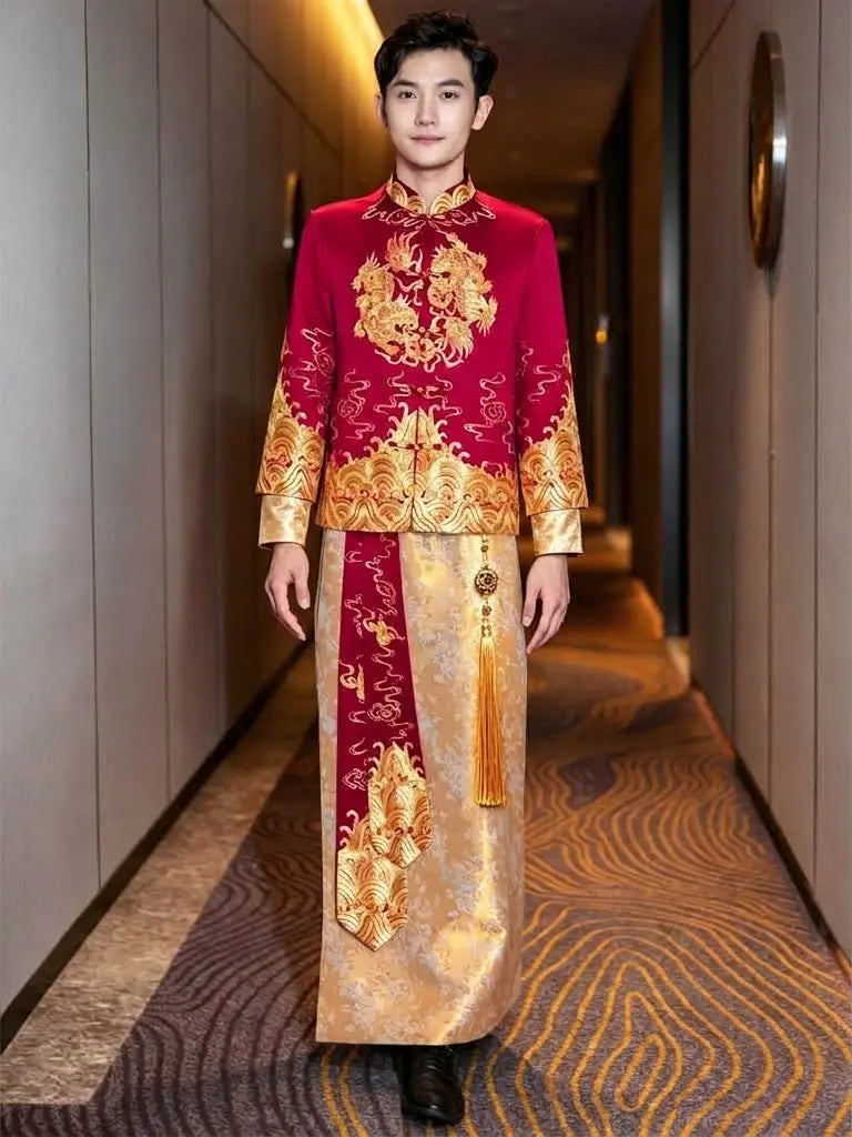 A man wearing a traditional Chinese wedding outfit (cheongsam) walking down a hotel hallway. The outfit is a deep red jacket with gold embroidery and a matching red-and-gold patterned skirt.