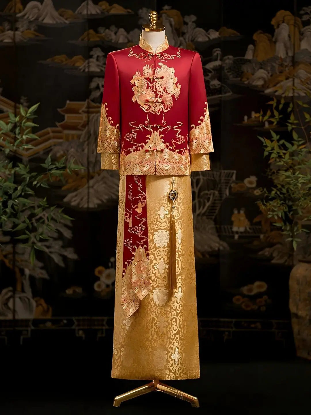 A traditional Chinese groom wedding outfit displayed on a mannequin, featuring a red jacket with gold embroidery and a matching gold skirt with brocade patterns.