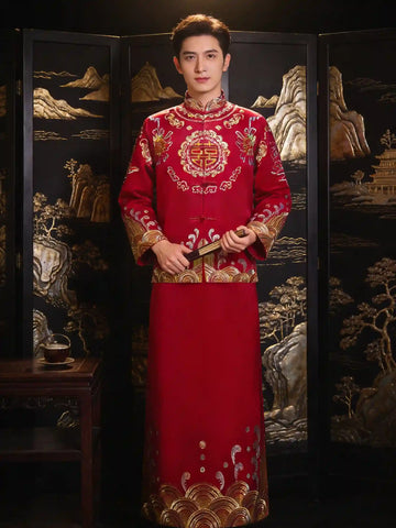 Man wearing a traditional red and gold embroidered  Double happiness Groom's Tang Suit Gown  in front of an ornate screen.