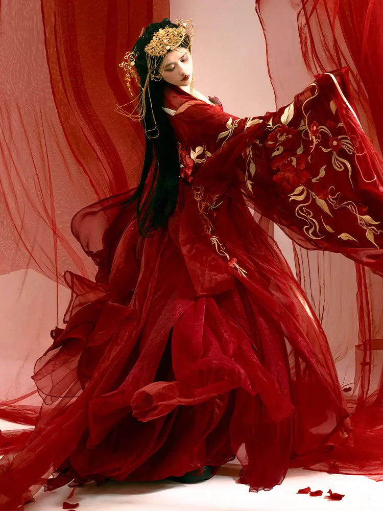 Woman in a Traditonal Chinese Red Embroidered Tang Dynasty Hanfu Set  with gold accents against a red curtain background