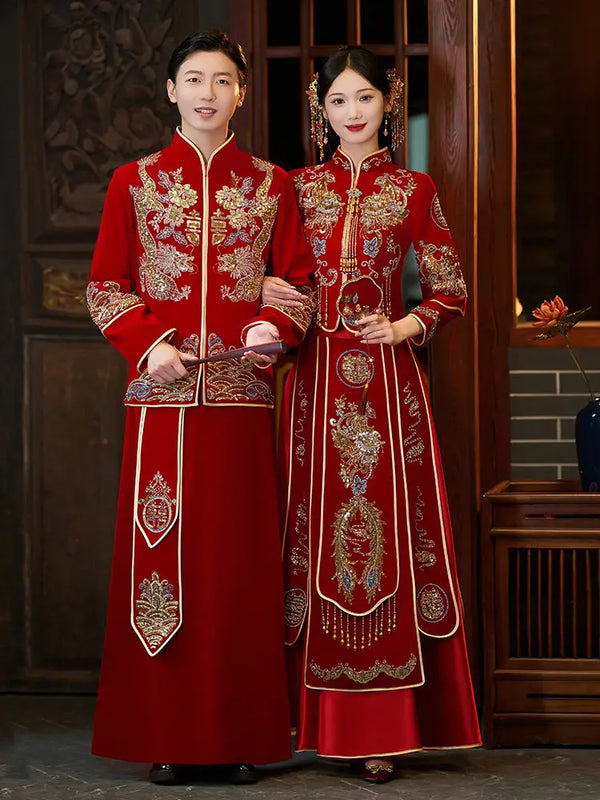 Groom and bride in Traditonal Chinese Wedding Phoenix & Dragon Qun Kwa Couple Suite outfits standing indoors.