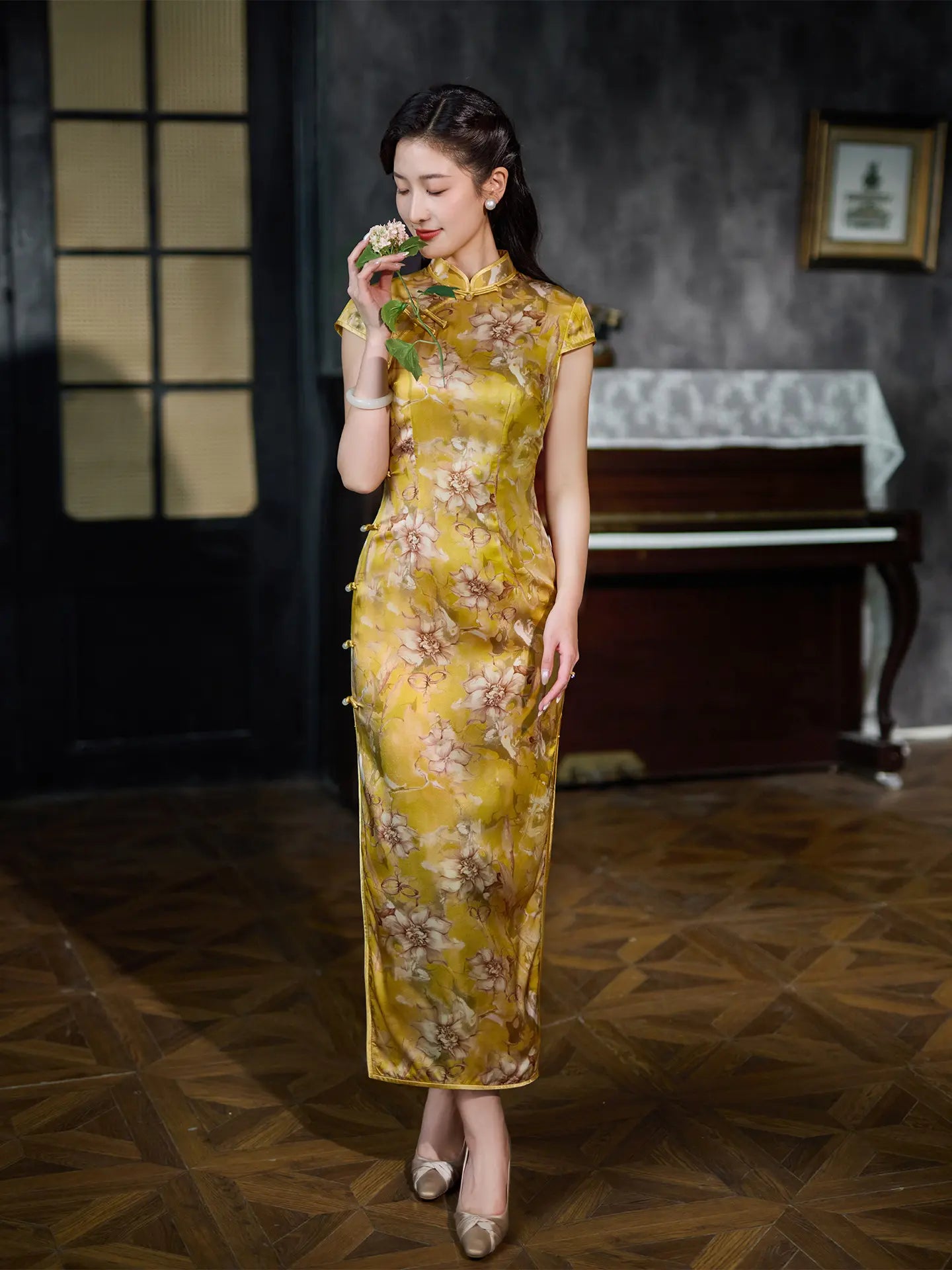 Woman in a yellow floral Vintage Gold Mulberry Silk Chinese Long Qipao Dress dress standing in a room with a piano.