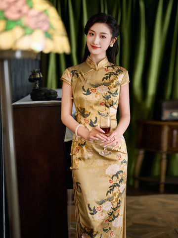 Woman in a traditional Vintage Gold Peony Silk Long Qipao Dress holding a glass in an elegant indoor setting.