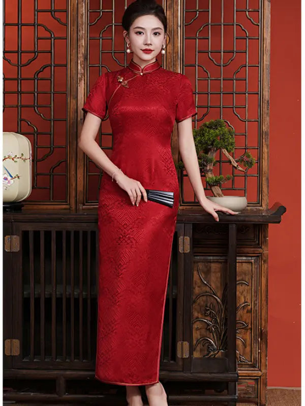 Woman in a red traditional Vintage Red  Short Sleeve Mulberry Silk Jacquard Qipao dress standing in front of a wooden cabinet with a red background.