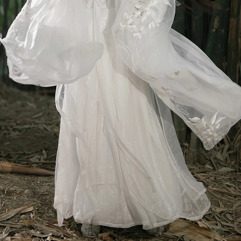 White Flowing Song Dynasty Hanfu dress with floral embroidery on a natural background