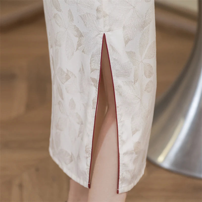 Close-up of a white  garment with a red trim on a wooden floor.