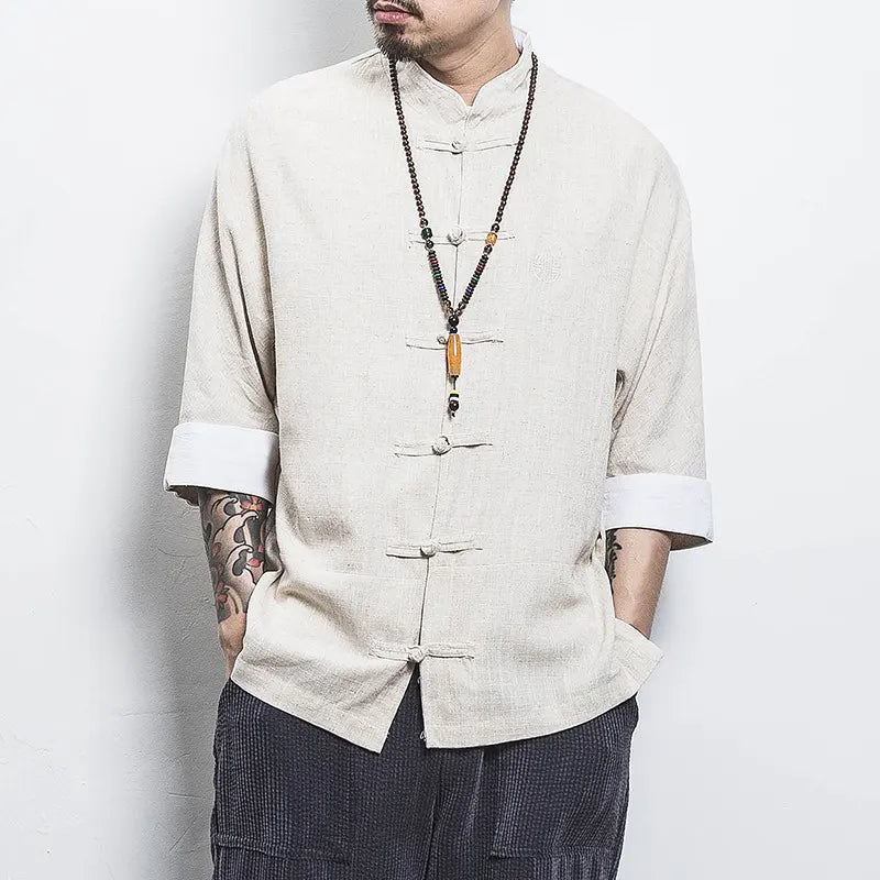 Man wearing a beige traditional Three-Quarter Sleeve Zen Heritage Linen-Blend Kong Fu Tang Shirt with rolled-up sleeves against a white background