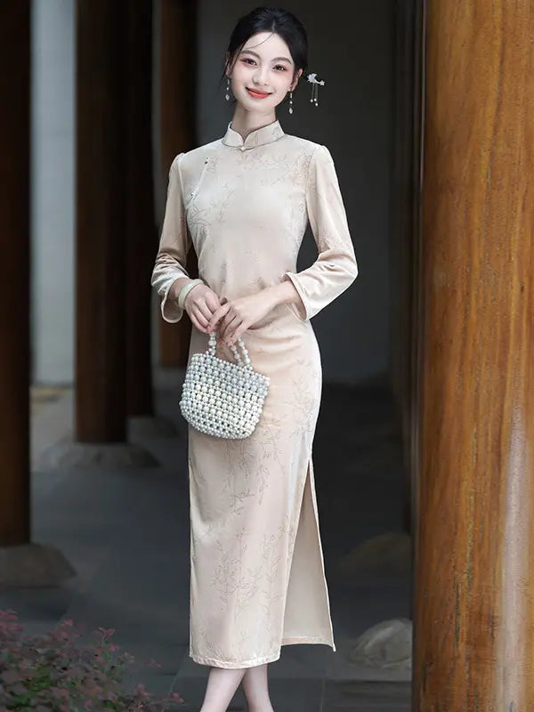 A woman models a beige long-sleeve Velvet Long Sleeve Qipao  cheongsam-style dress with a high slit, holding a small white woven handbag in a traditional courtyard setting with wooden pillars.