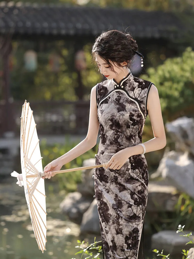 Woman in black Floral Sleeveless Velvet Qi pao Dress  holding an umbrella in a garden setting