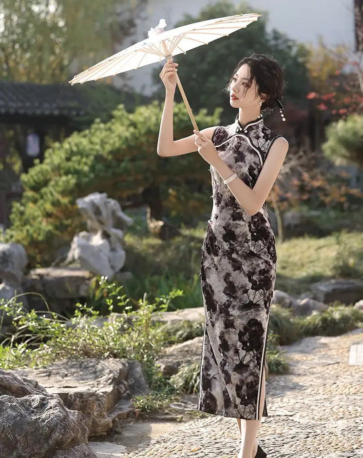 Woman in a black Floral Sleeveless Velvet Qipao Dress  holding an umbrella in a garden setting