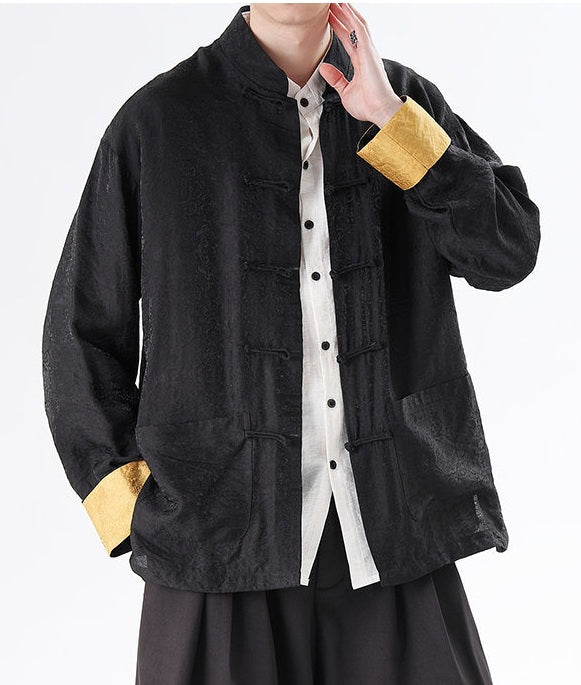 Person wearing a black Men's Oriental Jacquard Kung Fu Tang Shirt  with yellow cuffs and a white shirt underneath on a white background