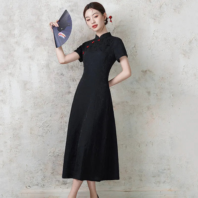 Woman in a black  Short Sleeve Floral A Line Qipao cheongsam  holding a fan against a textured wall