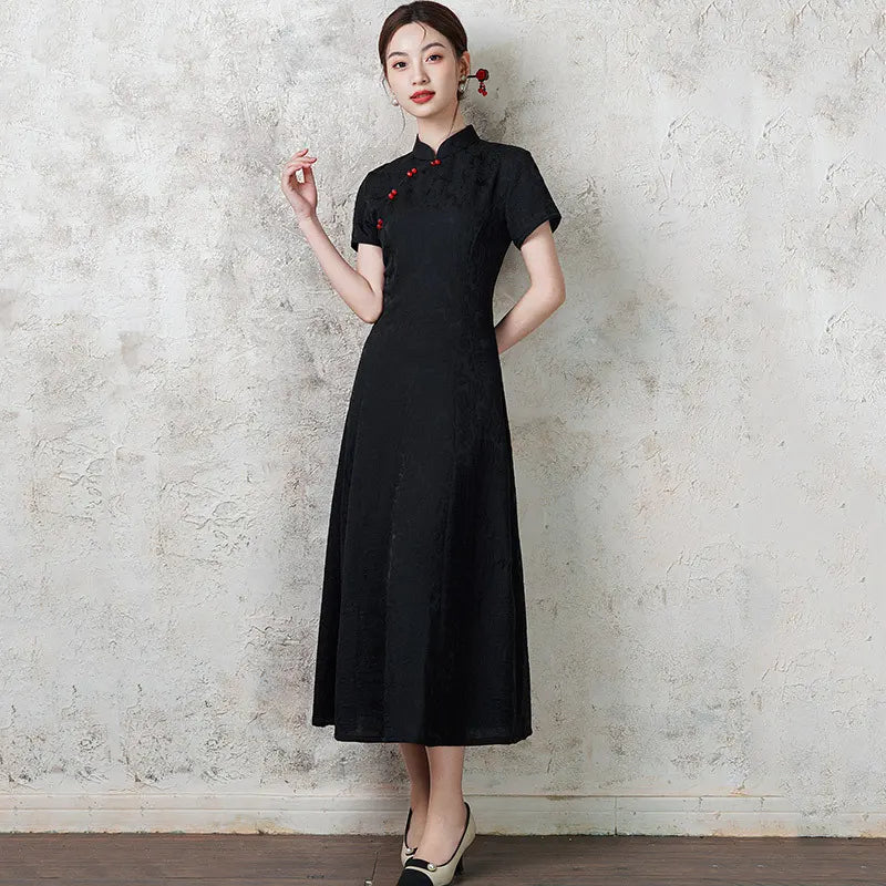 Woman wearing ablack  Short Sleeve Floral A Line Qipao cheongsam dress with red accents against a textured wall.