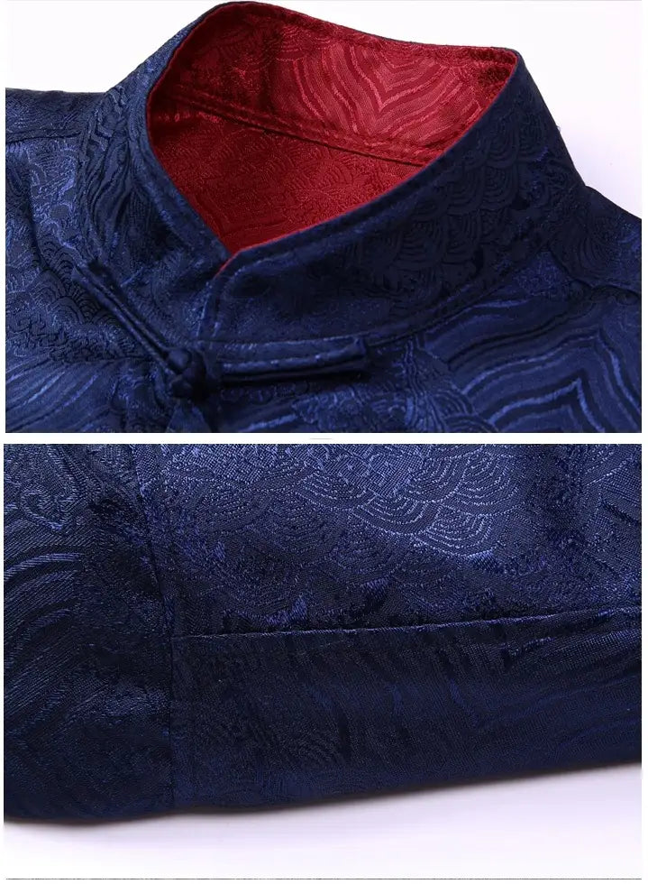 Blue embroidered garment with red lining on a white background