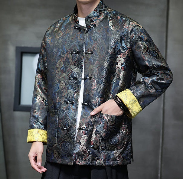 a  traditional Chinese  black Tang jacket made from brocade fabric features a rich, multicolored floral and swirl pattern with metallic accents and yellow cuffs