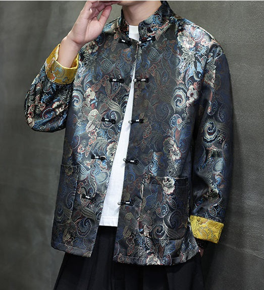 a  traditional Chinese  black Tang jacket made from brocade fabric features a rich, multicolored floral and swirl pattern with metallic accents and yellow cuffs