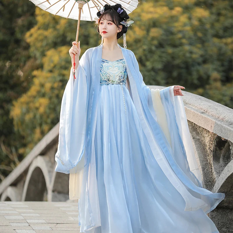 Woman in traditional light blue Chinese Tang Dynasty Ruqun Set Hanfu Dress holding an umbrella on a stone bridge