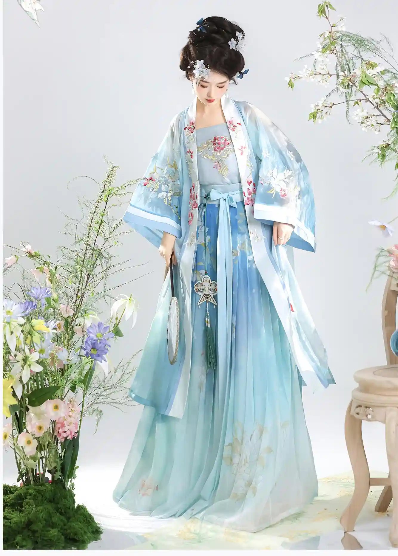 Woman in blue Traditional Chinese Dress – Elegant Song Dynasty Hanfu Set  with floral patterns against a white background