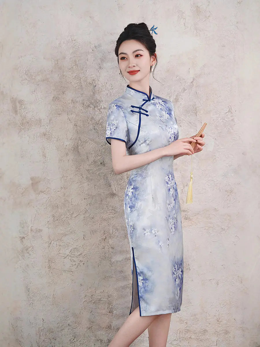 Woman wearing a blue Watercolor Floral Qipao cheongsam Dress  dress with a textured wall background