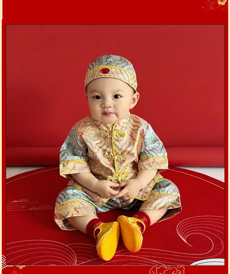 Baby wearing traditional Chinese outfit Blue and Gold Baby Tang Jacket Set on a red background